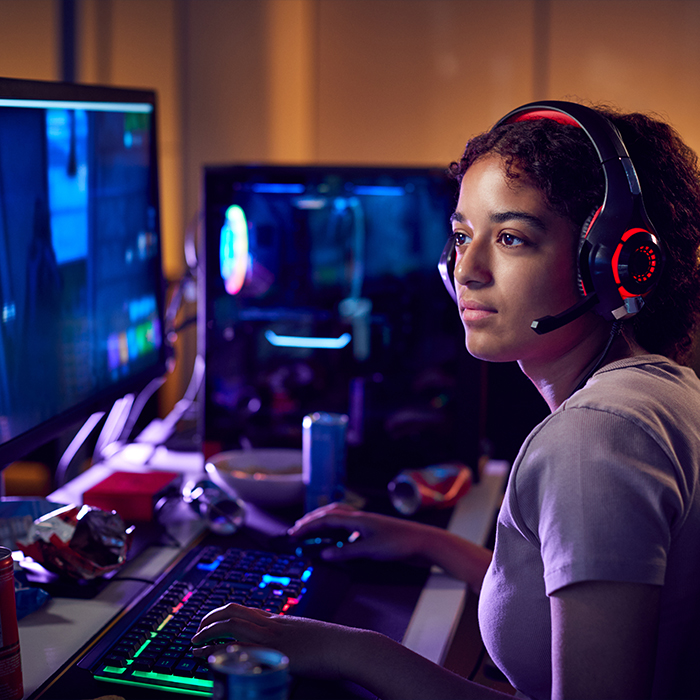 Cybersecurity Competition student wearing headphones sits at computer